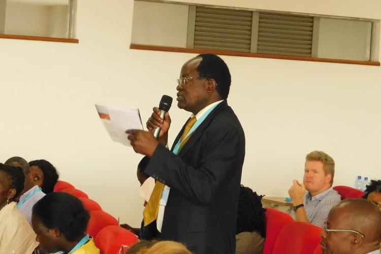 Prof. Stephen Anyango (CASELAP) engaging a presenter.  