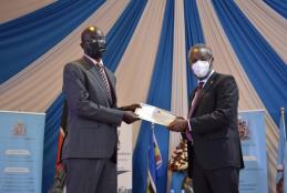 CASELAP Director, Dr Collins Odote receiving a certificate from UoN VC Prof. Stephen Kiama .